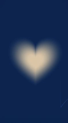 a white heart shaped object on a dark blue background