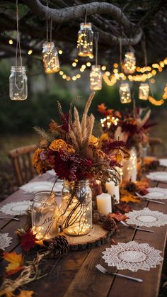 the table is set with candles, flowers and lace doily for an autumn - themed dinner