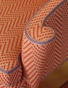 an upholstered bed with red and white patterns