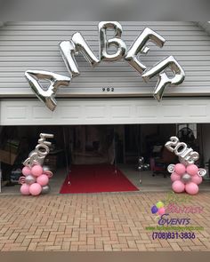 some balloons that are in the shape of letters and numbers on top of a garage door