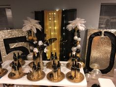 a table topped with lots of gold and black decorations