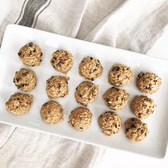 a white plate filled with oatmeal cookies on top of a tablecloth