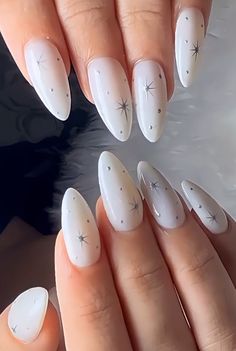 Drawn On Sparkle Nails, White Nails Silver Stars, White Acrylic Nails With Stars, White And Silver Star Nails, Winter Star Nails, Almond Nails Designs Stars, White Nails With Silver Stars, Star Burst Nails, Easy White Nail Designs