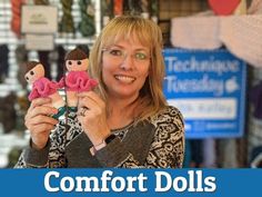 a woman holding up two dolls in front of her face with the words comfort dolls on it