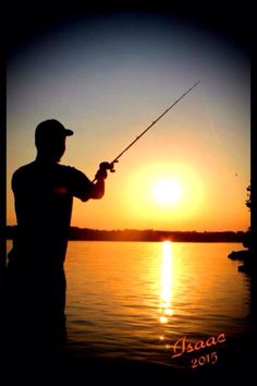 a man is fishing at sunset on the water