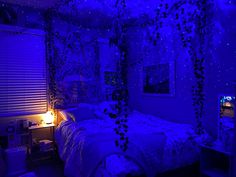 a bedroom with purple lighting and decorations on the walls