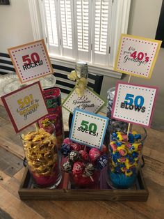 a tray filled with lots of candy and candies on top of a wooden table