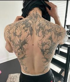 the back of a woman with tattoos on her body