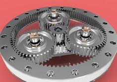 four gears are shown in the center of a metal object on a red background,