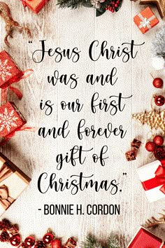 a christmas message with presents and gifts around it on a white wooden background that says, jesus christ was and is our first and forever gift of christmas