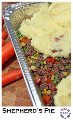 there are carrots and mashed potatoes in the pan with shepherd's pie