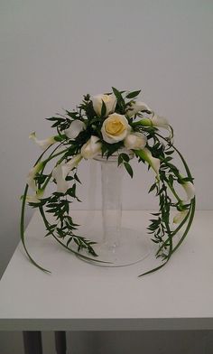 a vase filled with white flowers on top of a table