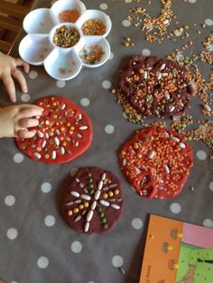 children's hands reaching for sprinkles on cookies and other food items