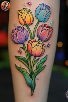 a colorful flower tattoo on the leg