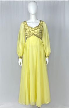 "-Sheer yellow fabric creates this awesome long sleeve gown -Bodice is decorated with clear rhinestones and sequins -The same detail is on the end of each sleeve -Fully lined -Metal zipper -Bust 34\" -Waist 26\" -Hips free -Length 52\" -Sleeve length 24\" This beautiful gown is in perfect condition." Yellow Long Sleeve Dress For Reception, Long Sleeve Dresses With Sheer Sleeves For Reception, Elegant Long Sleeve Yellow Gown, Fitted Yellow Embellished Gown, Yellow Embellished Fitted Gown, Yellow Long Sleeve Party Gown, Elegant Yellow Embellished Evening Dress, Glamorous Yellow Floor-length Evening Dress, Yellow Embellished Dress For Reception