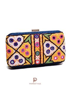 You'll look boho-chic with this Blueberry clutch. A classy and artistic handcrafted clutch. The Kutch Embroidery is a handicraft and textile signature art tradition of the tribal community of Kutch District in Gujarat. The embroidery with mirror work on this piece is unique and varies from piece to piece. It takes several days to hand embroider each piece. So, you are not purchasing a bag but a piece of art. This look is elevated to a whole new level by a breathtaking embroidery design. You can Embroidery With Mirror Work, Kutchi Work, Kutch Embroidery, Gala Gown, Look Boho Chic, Blue Clutch, Red Clutch, Embroidery Bags, Art Bag