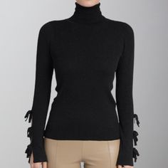 Experience the ultimate comfort and style with our Love Token Sage Sweater in classic black. This chic piece features a cozy turtle neck and feminine bow detailing on the sleeves, adding a touch of elegance to any outfit. Embrace the love and warmth in this must-have sweater! Elegant Black Turtleneck For Fall, Elegant Stretch Black Sweater, Elegant Solid Winter Turtleneck, Elegant Solid Turtleneck For Winter, Chic Fall Turtleneck, Elegant High Neck Turtleneck For Fall, Chic Black Turtleneck For Fall, Elegant Black Fitted Sweater, Elegant Stretch Turtleneck