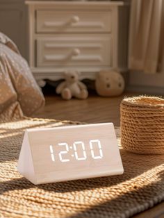 an alarm clock sitting on top of a wooden table