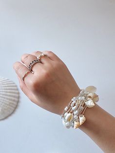 Made to order 100% DEEP Ocean shells and conch  100% Natural Shinny Pearls. A chain is made of High Quality elastic strings, PLS DO NOT PULL UP TOO HEAVILY!! NO WORRIES, We've tested for more than 50 times to pull up and down. looks LUXURY and SUPER CUTE. Bohemian Pearl Beaded Bracelets In Silver, Bohemian Silver Pearl Beaded Bracelets, Silver Shell Jewelry With Pearl Charm, Adjustable Mother Of Pearl Bracelets For Weddings, Elegant Silver Strand Jewelry, Adjustable Mother Of Pearl Wedding Bracelets, Beach Jewelry: Silver With Pearl Charm, Beach Jewelry With Silver Pearl Charm, Silver Beach Jewelry With Pearl Charm