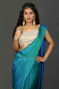 Engage your personality with the luxurious feel of this Satin One Minute Saree in Peacock Blue dual tone shades. It is paired with a stunningly shimmering beige blouse. Drape this specially for any festive, party, or wedding occasion.Product Features: Saree Color: Peacock Blue Blouse Color: Blue Saree Fabric: Satin Blouse Fabric: Blue Art Silk (Blouse Color: Blue Art Silk (For beige metallic blouse choose the fabric option at check out) Work: Ombre Shoulder Drape: Customer must select the should Peacock Blue Banarasi Saree, Peacock Blue Blouse, Cocktail Party Wedding Reception, One Minute Saree, Party Wedding Reception, Teal Ombre, Color Peacock, Beige Blouse, Metallic Blouses