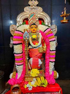 the statue is decorated with flowers and other decorations