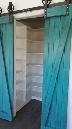 an open closet with sliding doors and shelves