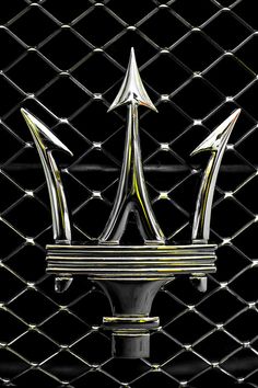 an image of a crown on a metal grilling door with rivets in the background