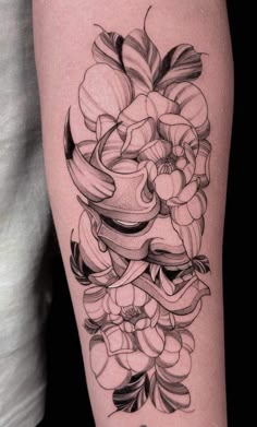 a woman's thigh with flowers and ribbons on her leg, in black and white