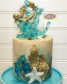 there is a cake decorated with blue and gold decorations