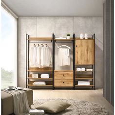 an open closet with clothes hanging on the shelves and pillows on the floor next to it