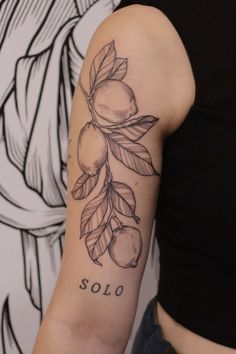 a woman's arm with an olive branch tattoo on it, and the word solo written in cursive writing