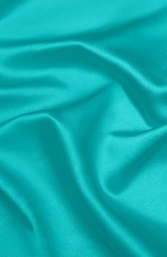 a close up view of the teal colored fabric that is very soft and smooth