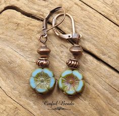 Looking for a distinctive addition to your boho jewelry collection? Look no further than these antique copper dangle earrings! Featuring stunning 12mm sky blue Czech glass Hawaiian Hibiscus flower beads, these earrings will catch the eye of anyone who sees them. Accented with tibetan style antique copper spacer beads, these earrings have a vintage feel that perfectly complements their boho style. And with your choice of kidney wires, lever back, or hook earwires, you can customize your earrings Adjustable Copper Flower Earrings, Adjustable Copper Flower Jewelry, Unique Copper Flower Jewelry, Bohemian Jewelry With Flower-shaped Matching Earrings, Bohemian Flower-shaped Jewelry With Ear Wire, Bohemian Jewelry With Matching Flower-shaped Earrings, Handmade Czech Glass Flower Earrings In Vintage Style, Bohemian Turquoise Flower Shaped Jewelry, Handmade Czech Glass Vintage Flower Earrings