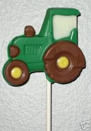 a green and brown tractor lollipop on a stick