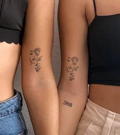 two women with tattoos on their arms