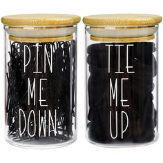 two glass jars with black and white writing on the lids that say pen me up