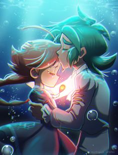 a couple kissing under the water in an underwater scene with sunlight shining on their faces