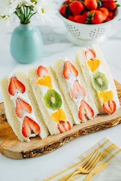 slices of cake with fruit on them sitting on a cutting board