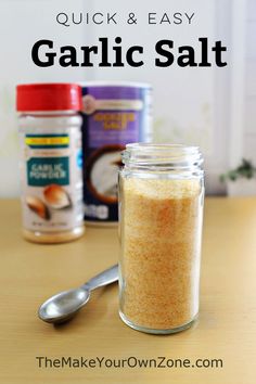 an image of garlic salt in a glass jar with spoons on the table next to it