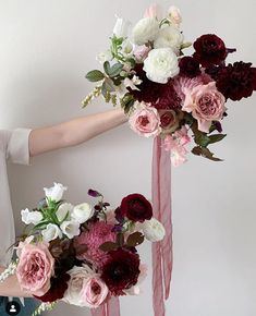 a woman holding a bouquet of flowers in her hands