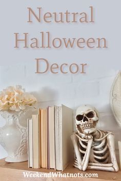 a skeleton sitting on top of a wooden table next to books and vases with flowers