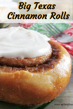 a close up of a doughnut with icing on it and the words, big texas cinnamon rolls