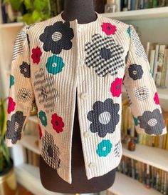 a mannequin wearing a jacket with flowers on it