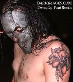 a shirtless man wearing a metal mask