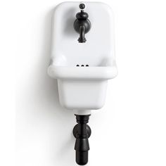 a white sink mounted to the side of a wall with a faucet and soap dispenser