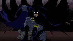 the batman animated character is standing in front of a cityscape