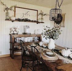 a wooden table topped with lots of white dishes