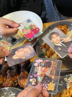 several people holding up pictures of themselves in front of some fried chicken and other food