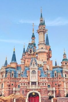 the entrance to an old castle with blue and gold domes on it's roof