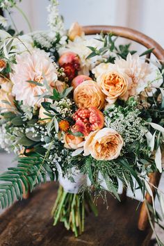 a bouquet of flowers sitting on top of a wooden table